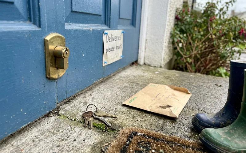 Front door euro cylinder lock with keys on the step